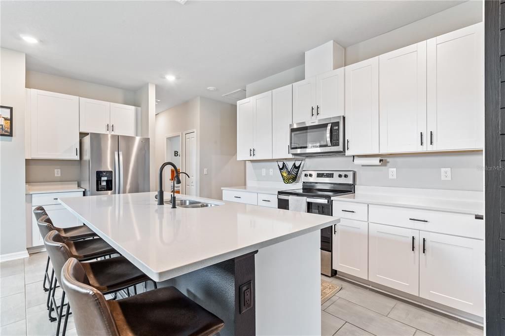 The kitchen sits in the center of the home in this split floorplan.