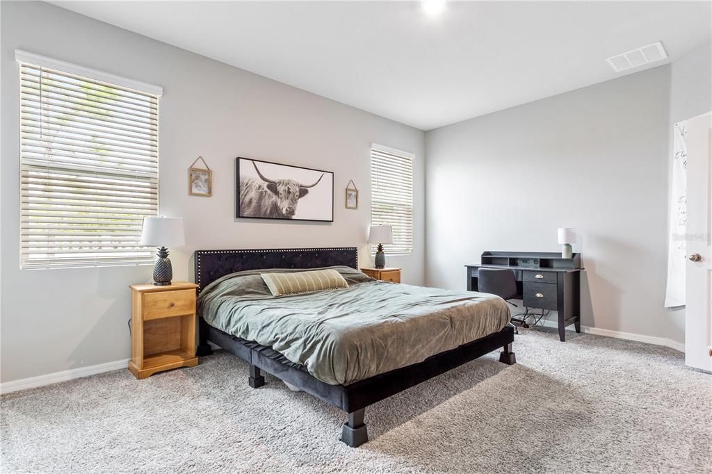 Primary bedroom with view of backyard.