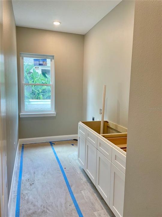 Laundry room- cabinets and sink.