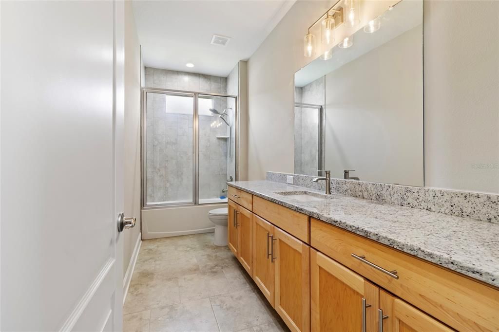 Ensuite  bath for the front bedroom features granite ctops, custom lighting and tiled shower to the ceiling. Glass shower doors in both secondary baths.