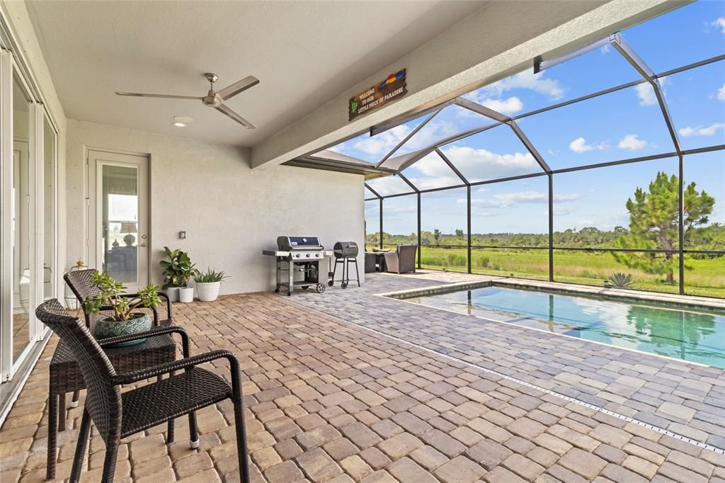 Covered lanai area features outdoor speakers and ceiling fans.