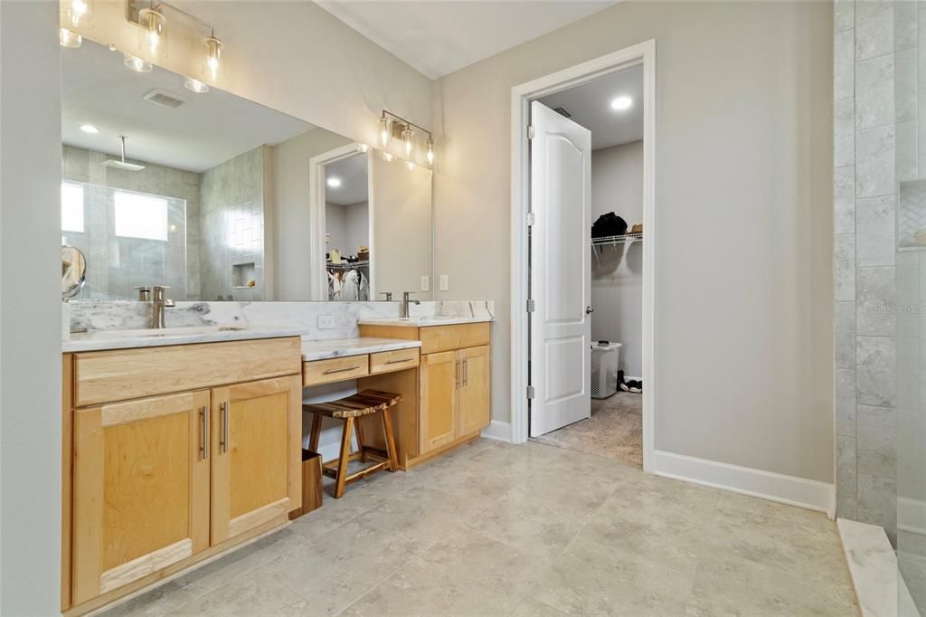 Dule sinks, vanity area all tops by the same marble as the kitchen. Large walk-in closet-of course!