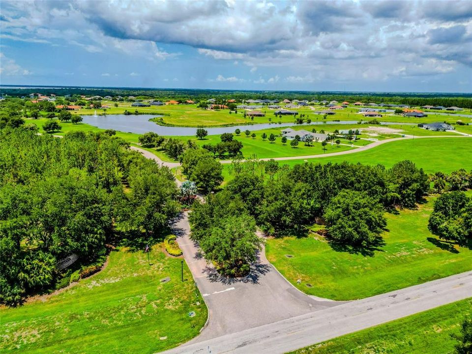 Below the tree line is a gated entry to paradise known as Lake Toscana.