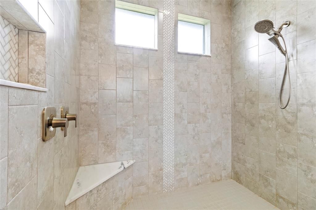 Lovely tile work and trim details in the oversized Owner's Shower.