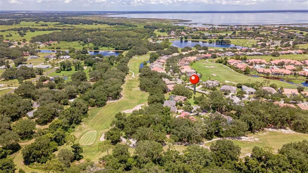 Aerial view of corner lot with the #2 green and #3 tee box to the left of the vacant lot pin.