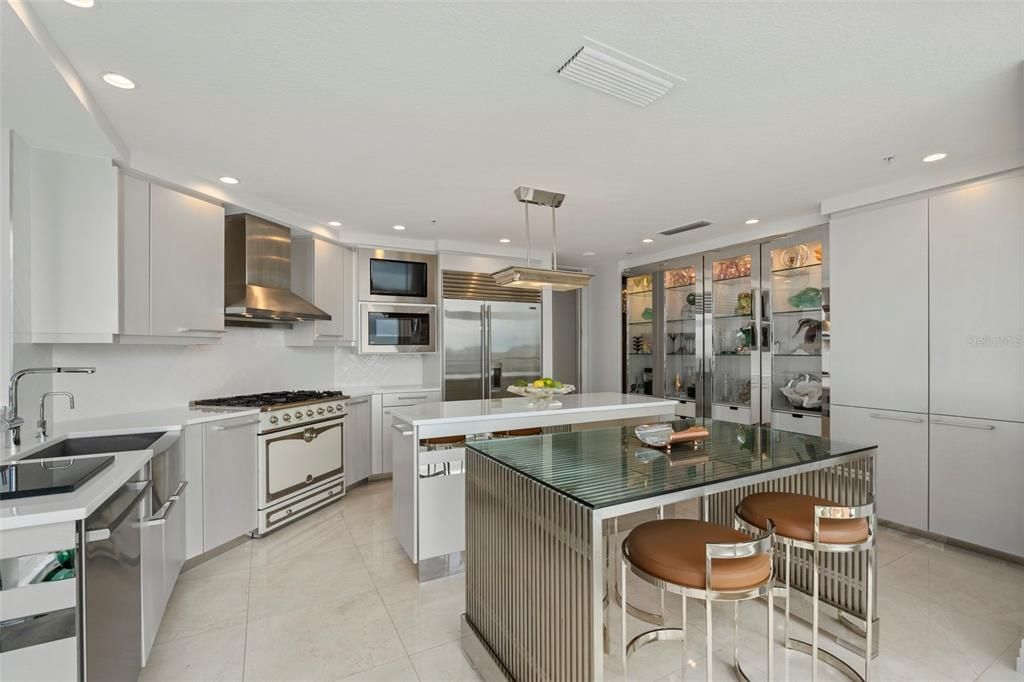 The kitchen has a classic white subway tile backsplash in a herringbone pattern and an ample-sized pantry.