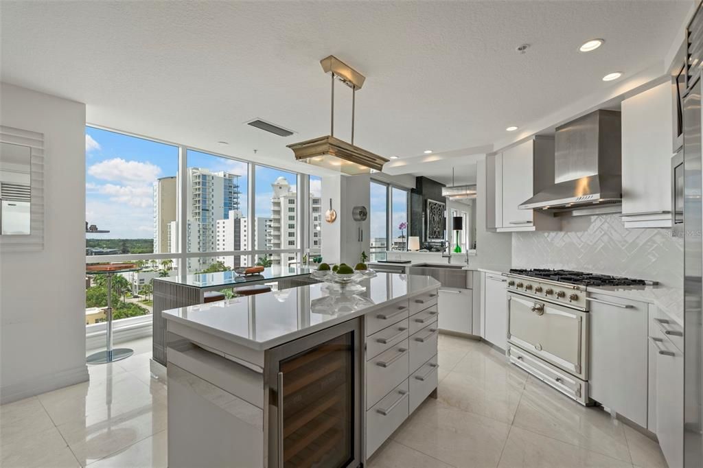 The state-of-the-art kitchen features a La Cornue range boasting 5 gas burners and a Wolf stainless hood.