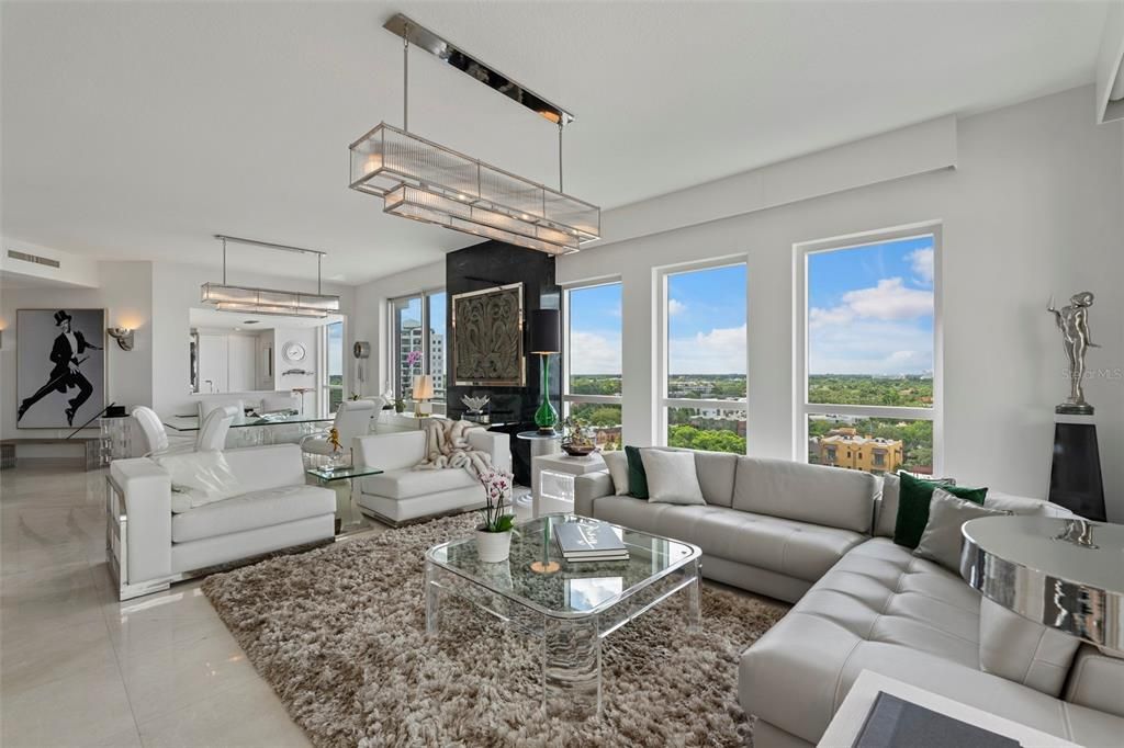 The living room and adjacent large dining room feature designer lighting.