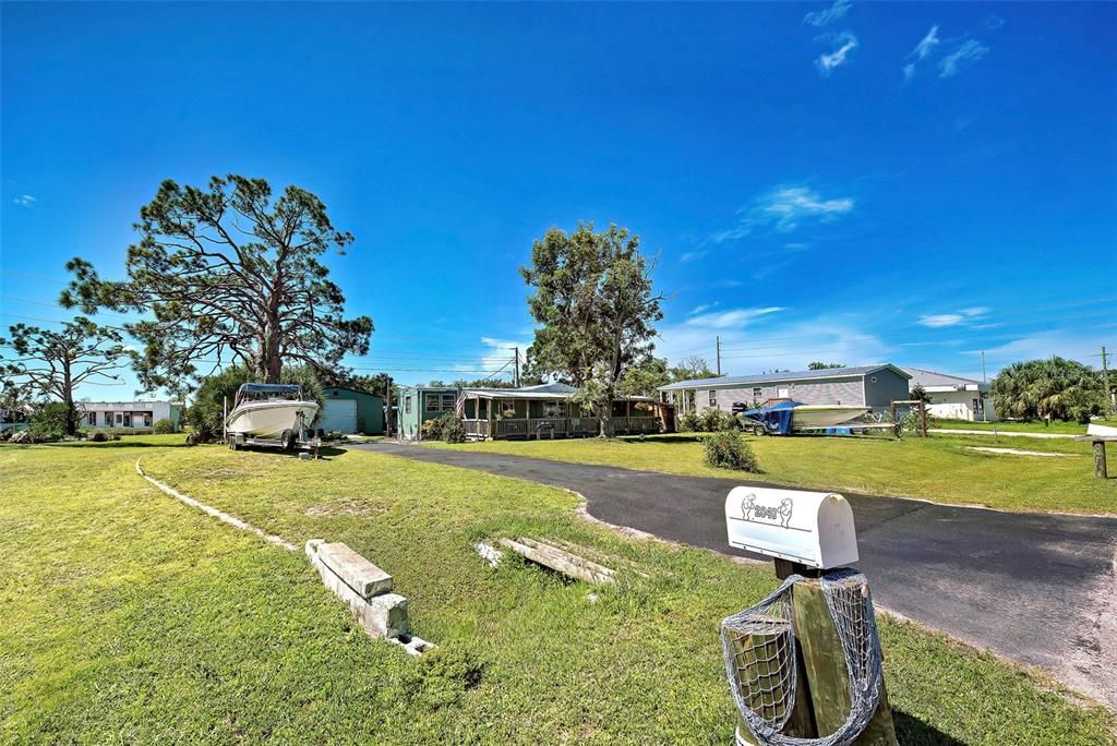 Long paved driveway with plenty of room to park your big boy toys.