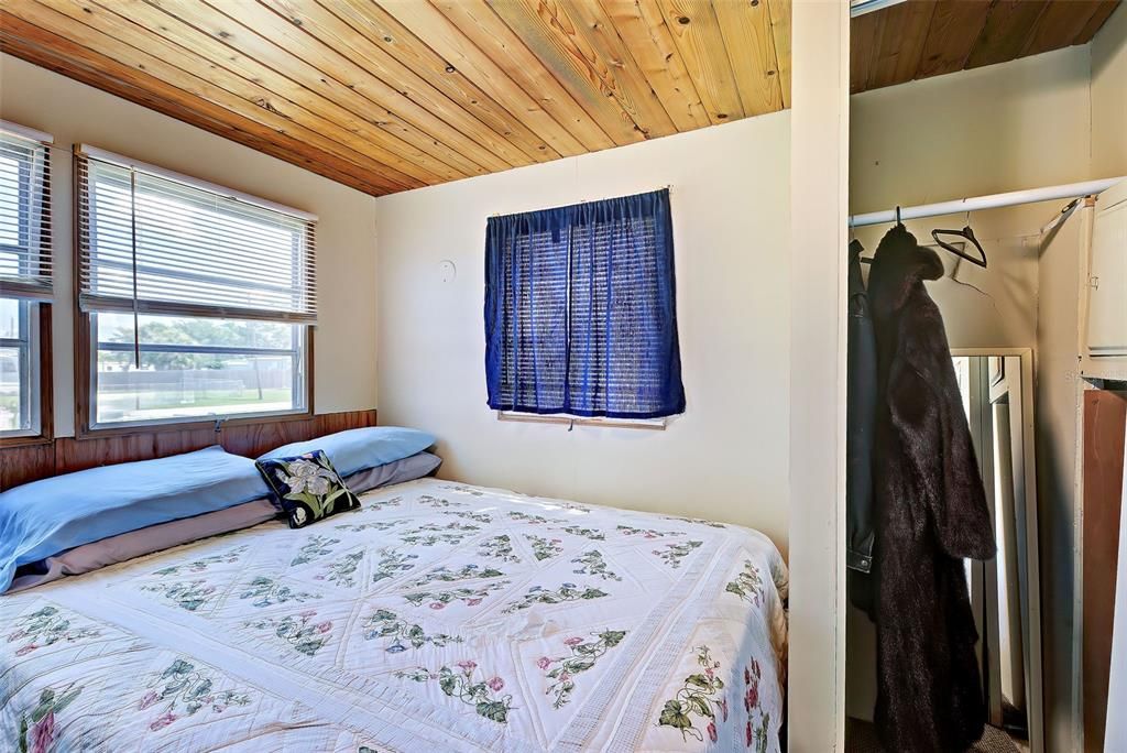 There is plenty of room in the bedroom for a large bed. And the knotty pine accent continues on the ceiling.