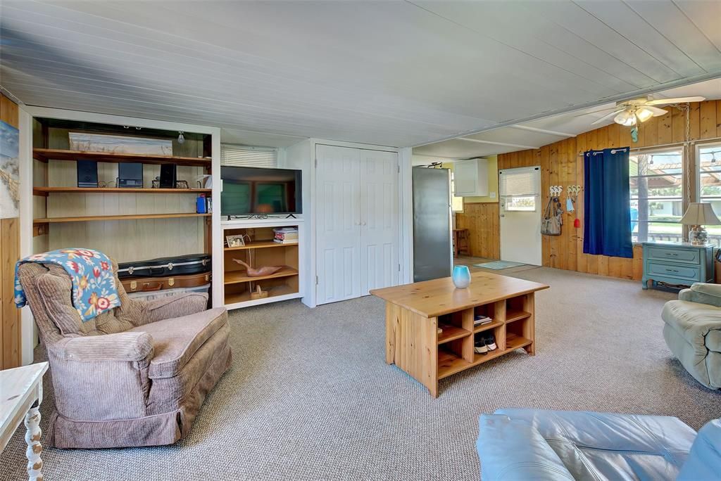 Large, open living room with book shelves.