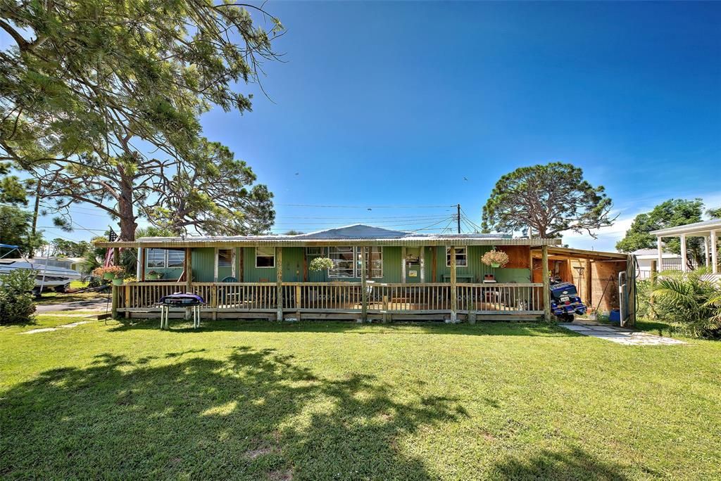 Beautiful Florida style home on a large lot with an inviting front porch.