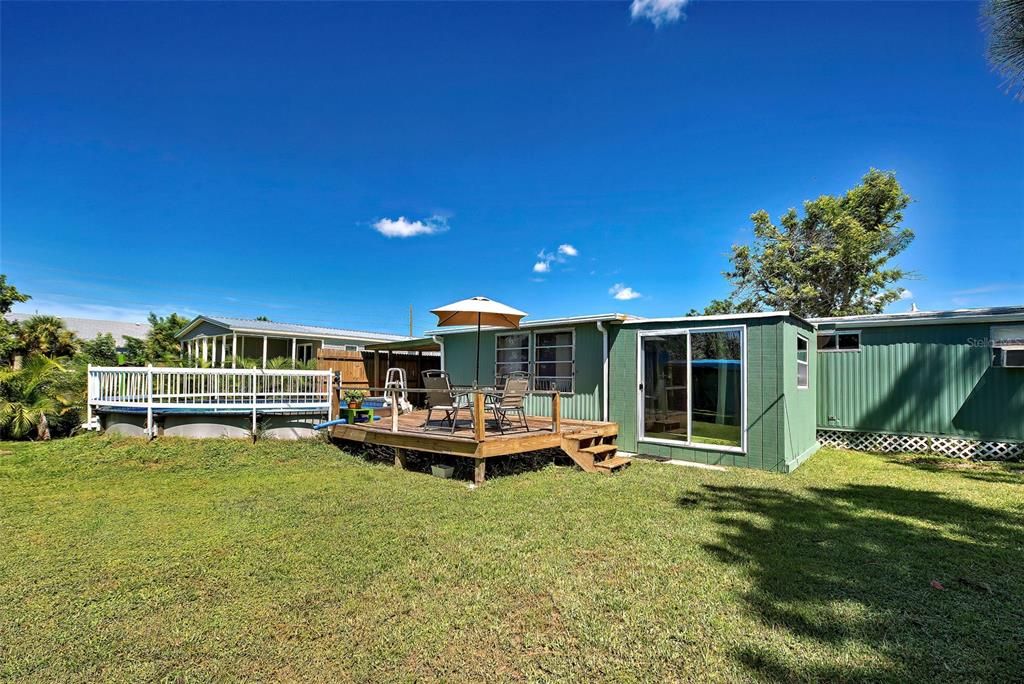 pool is built partially into the ground with a deck.