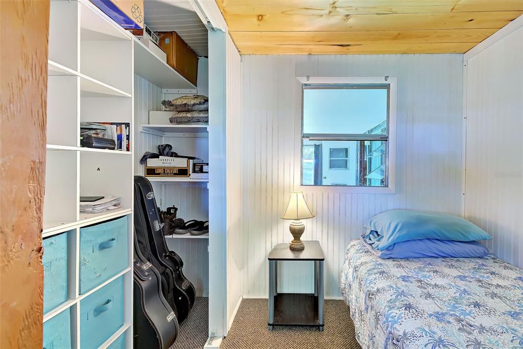 The second bedroom contains built in drawers and shelves.