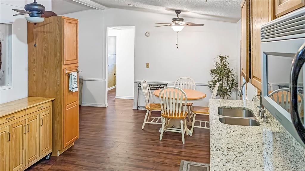 View of Kitchen & Dining Room with Laundry Room and Carport Back Entrance behind  you!