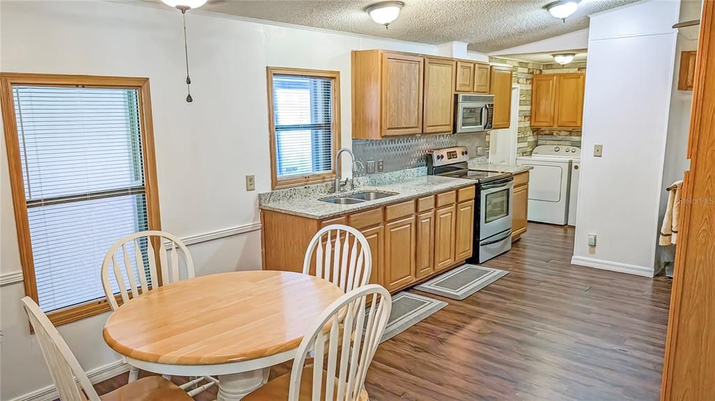 View of Dining Room and Kitchen! Home has been REMODELED & is Gorgeous Inside with Granite Counters in all Baths and Kitchen and Stainless-Steel Appliances!