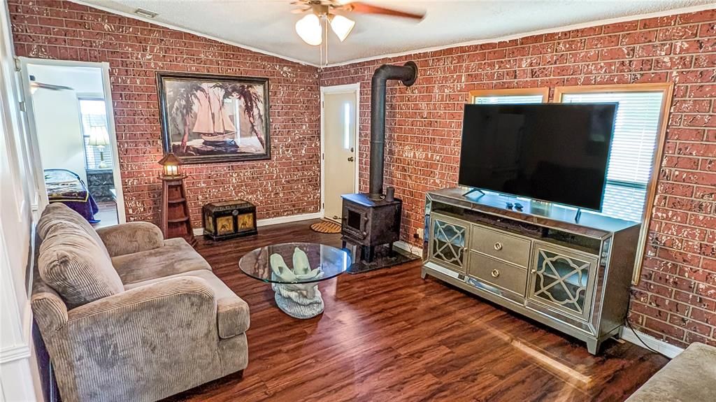 Living Room, View #1! Cozy Old-Fashioned Wood Cook Stove Give Your home a Touch of Elegance! Hardwood Laminate Flooring throughout Make the entire Home Glow!