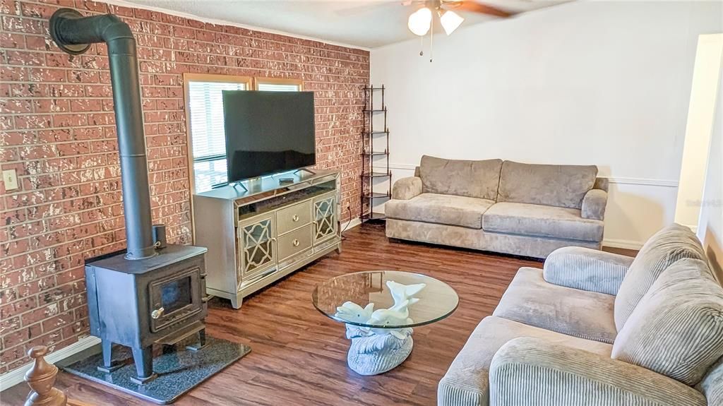 Living Room, View #2! Cozy Old-Fashioned Wood Cook Stove Give Your home a Touch of Elegance! Hardwood Laminate Flooring throughout Make the entire Home Glow!