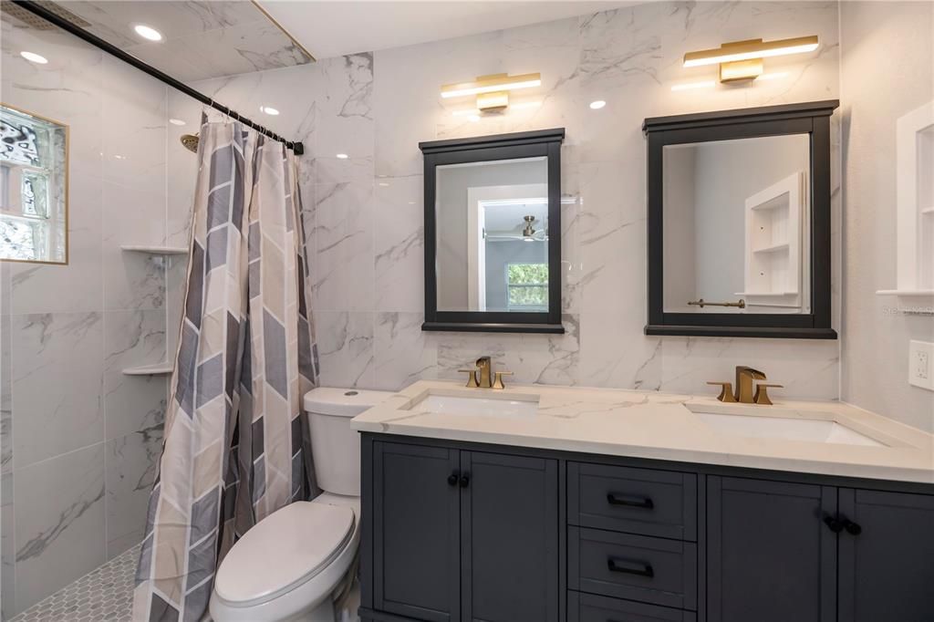 master bath with dual sinks and gorgeous shower