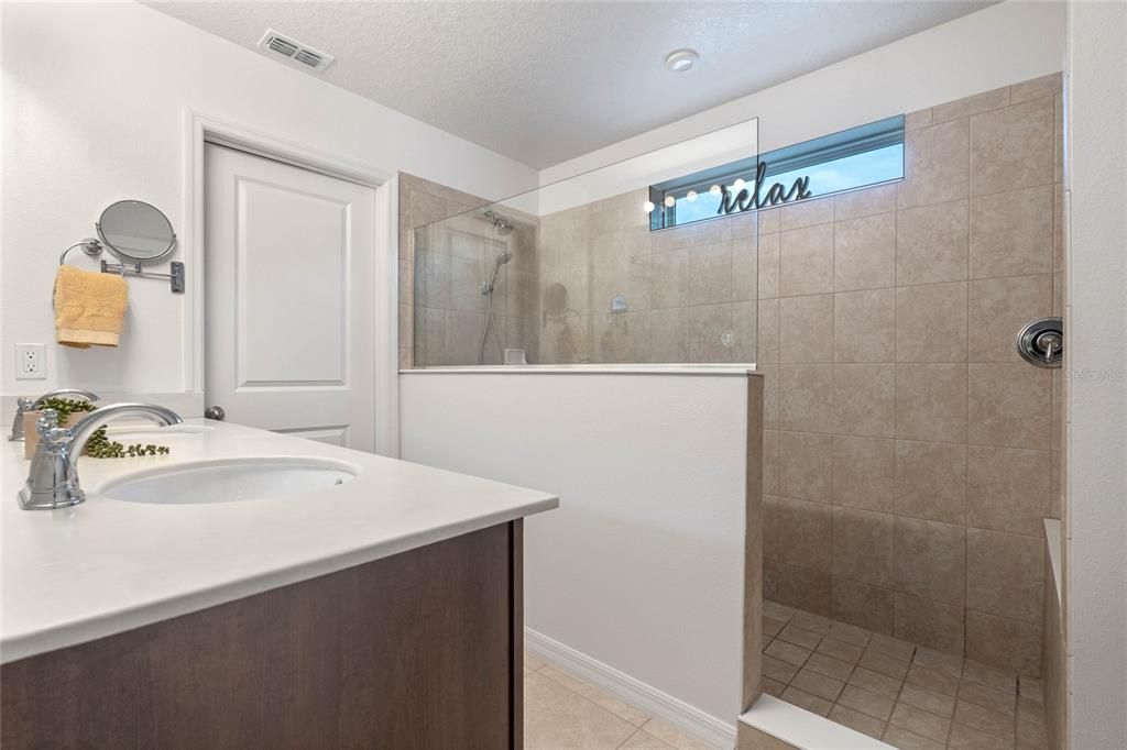 Oversized Shower in Primary Bathroom with Dual Sink Vanity and Separate Water Closet