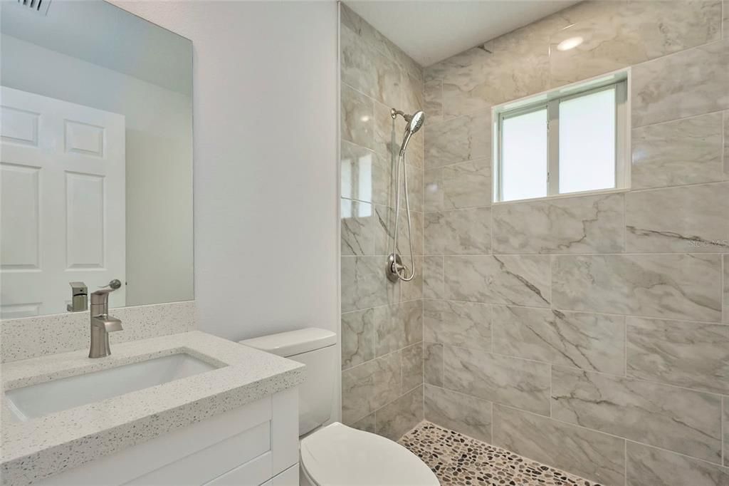 Guest bathroom that is located between the secondary bathrooms