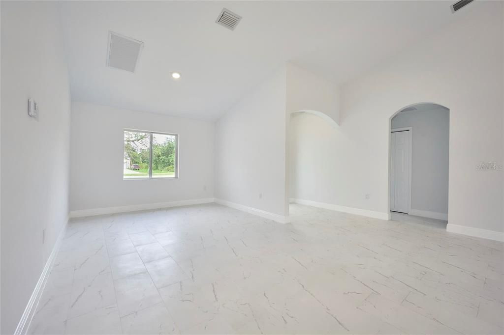 Doorway to right leads to two secondary bedrooms and full guest bath