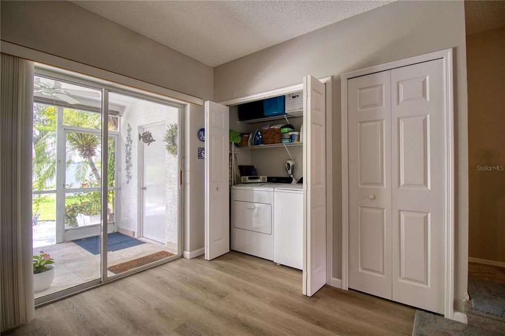 Washer and dryer hidden next to the pantry in the kitchen