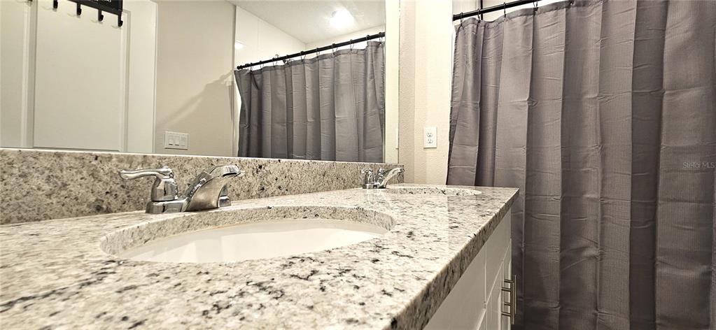 Master bathroom includes dual sinks and granite countertops