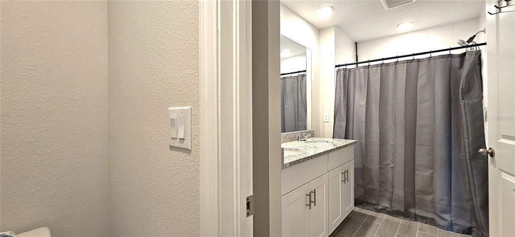 Master bathroom includes a walk-in tiled shower