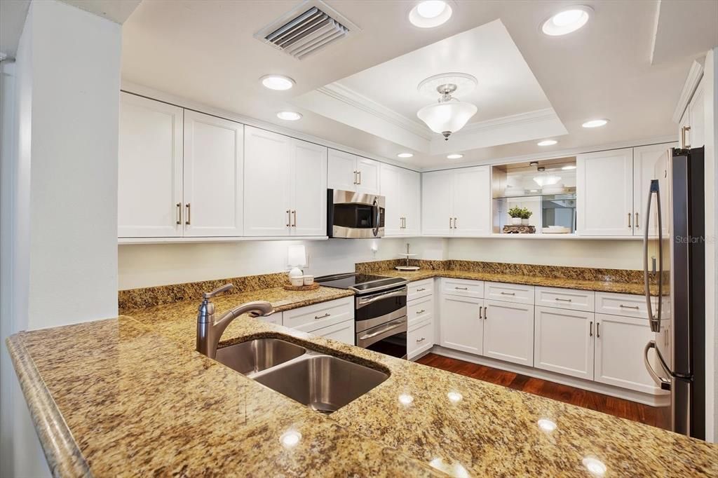 Open concept kitchen overlooking the dining and living rooms.