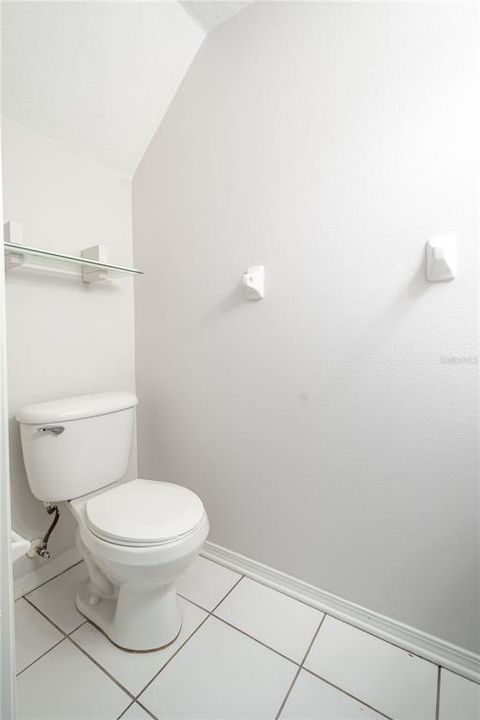 1st floor bathroom features ceramic tile flooring and neutral tones.