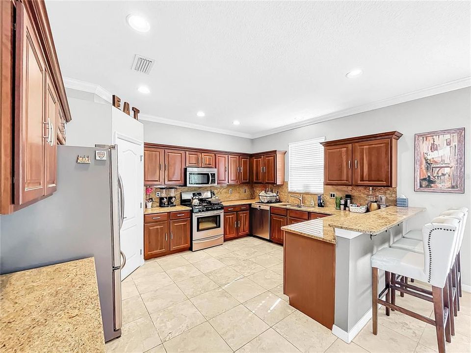 The large gourmet kitchen has plenty of counter space and cabinets.  A large pantry and opens up to the family room.  Perfect for entertaining.