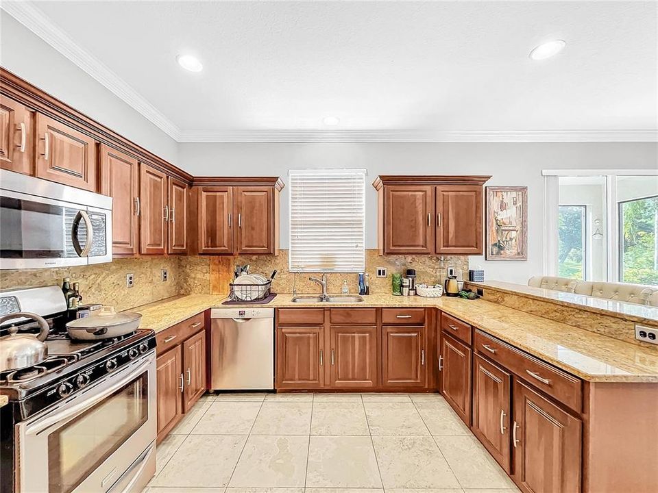 The large gourmet kitchen has plenty of counter space and cabinets.  A large pantry and opens up to the family room.  Perfect for entertaining.