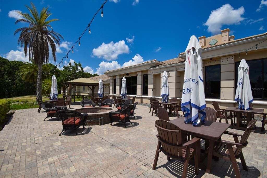 The outdoor area outside the golf club/restaurant has a large fire pit.