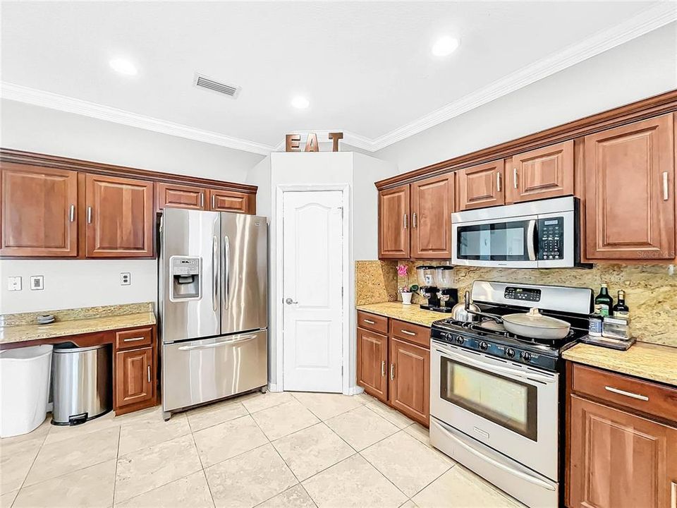 The large gourmet kitchen has plenty of counter space and cabinets.  A large pantry and opens up to the family room.  Perfect for entertaining.