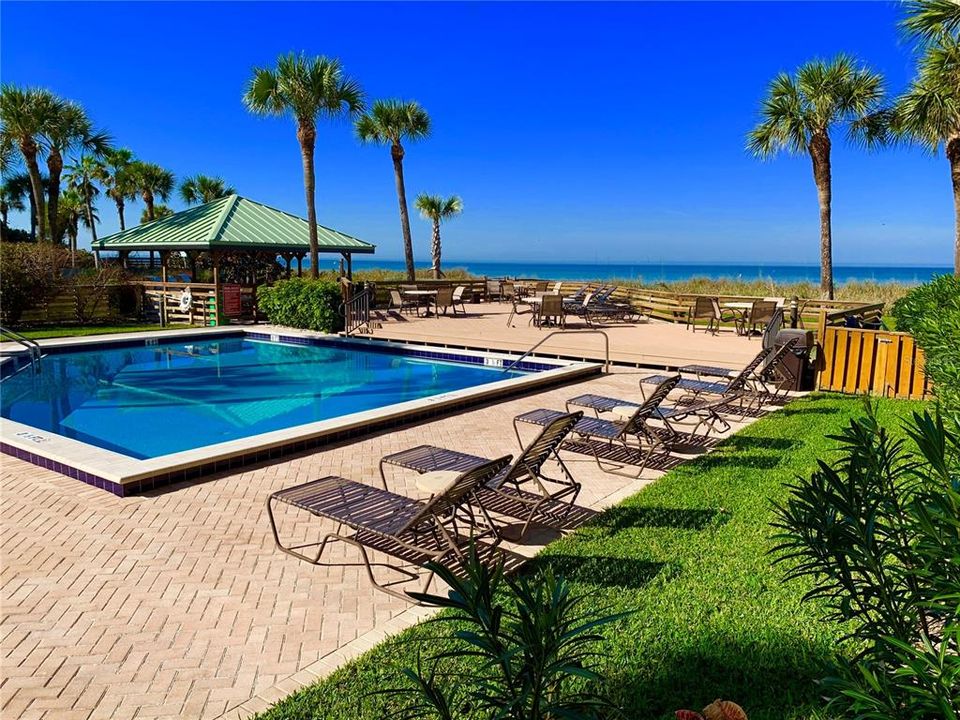 Seaside pool sparkles in the sunshine, surrounded by plenty of seating for lounging and dining on the paved pool deck, the raised wooden deck or the Gazebo deck.