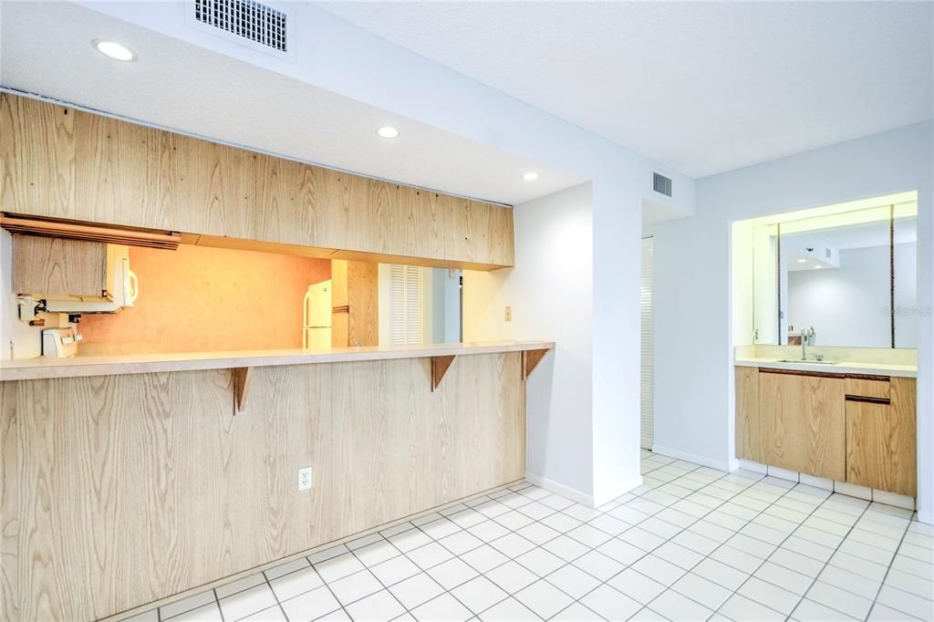 Dining area with bar that opens to kitchen for additional seating and a wet bar for entertaining.