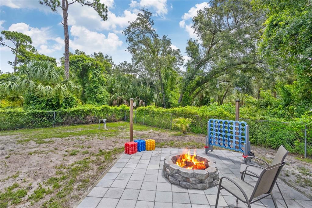 BRICK PAVER FIRE PIT SURROUNDED BY FENCED YARD