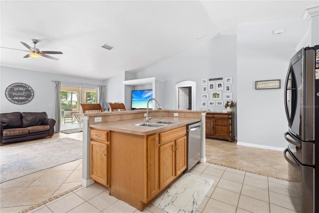 KITCHEN OVERLOOKING FAMILY ROOM AND LANAI