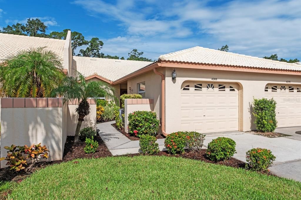 Private sidewalk from driveway to front courtyard entry