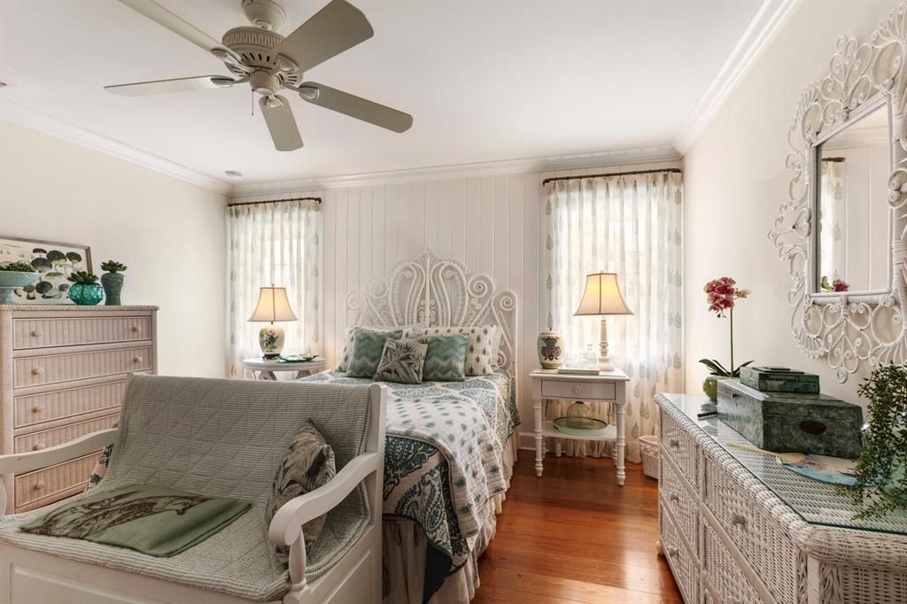 bedroom 2 w/ fan, crown molding, shiplap accent wall