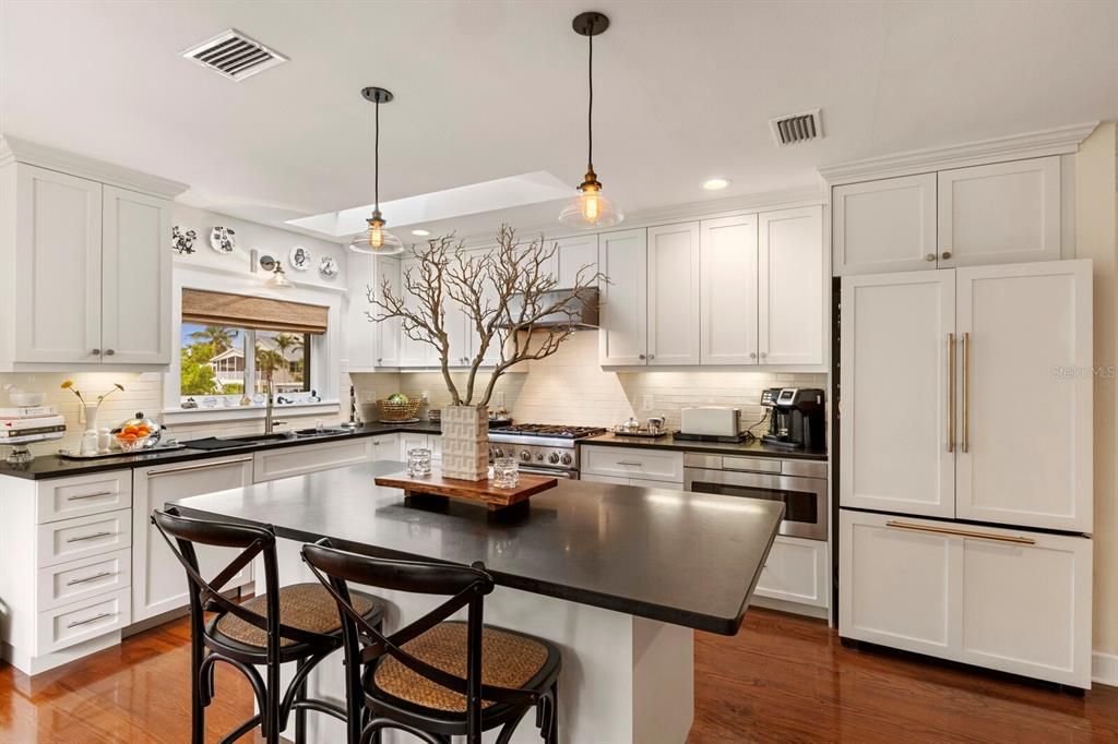 kitchen island w/ counter seating and custom Jenn-Aire fridge/freezer