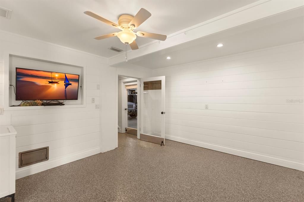 bonus room on first floor w/ sink, epoxy floors, shiplap walls and under AC