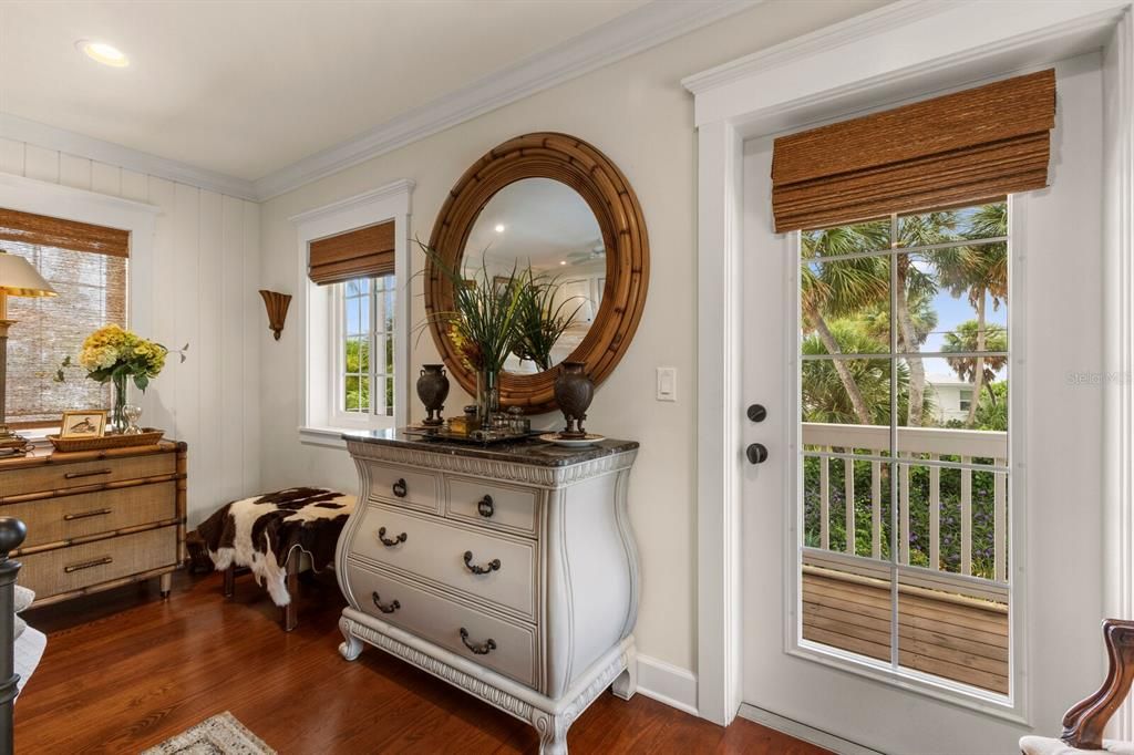 Door leading out to private patio off of the primary bedroom