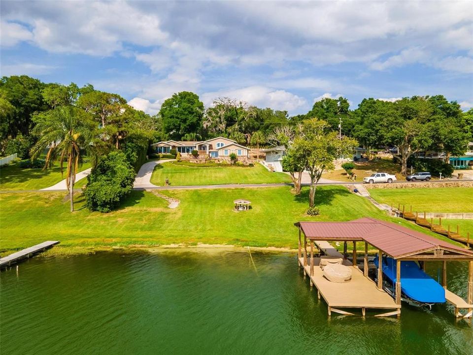 View of the house from the lake.  Small pump house in the photo is for irrigation pump that uses lake water.