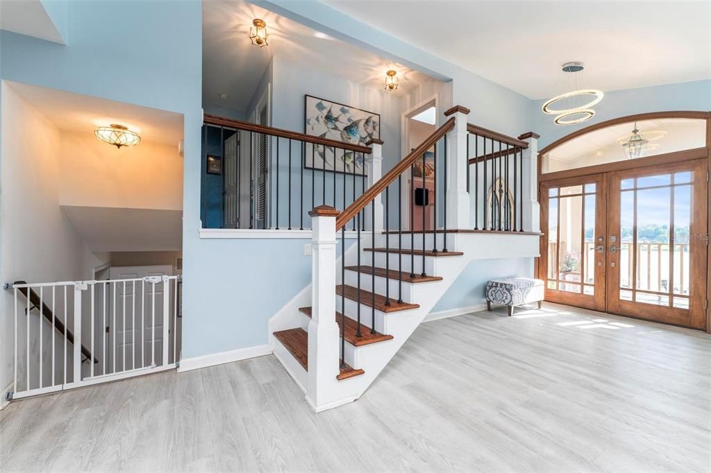 Home entrance and stairway to upper lever with 2 bedrooms and on-suite bathrooms.  Also featured is stairway to lower level.