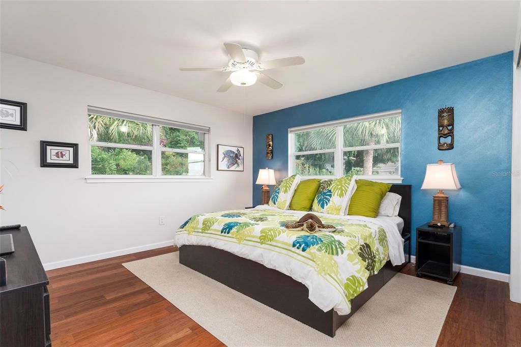 Bedroom 2 with wood floors and ensuite bathroom.