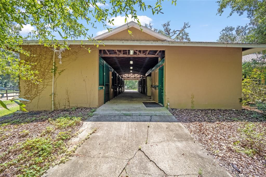 Center Aisle 8 Stall Barn with A/C office, A/C Tack, inside wash rack and entrance to house