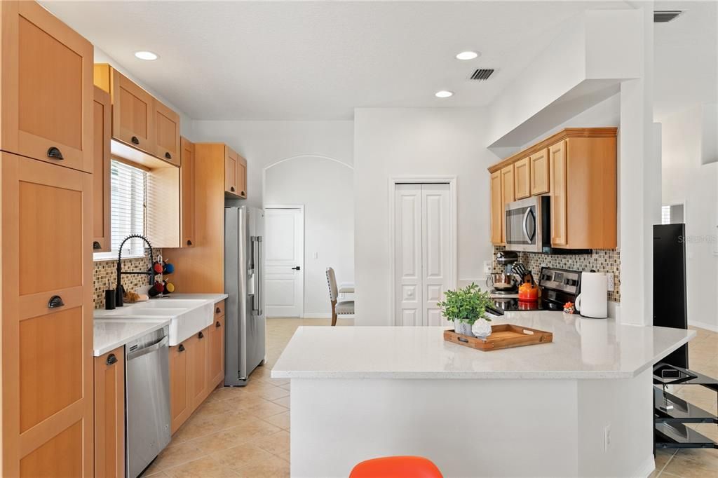 Kitchen with closet pantry and entry to formal dining room off garage entry