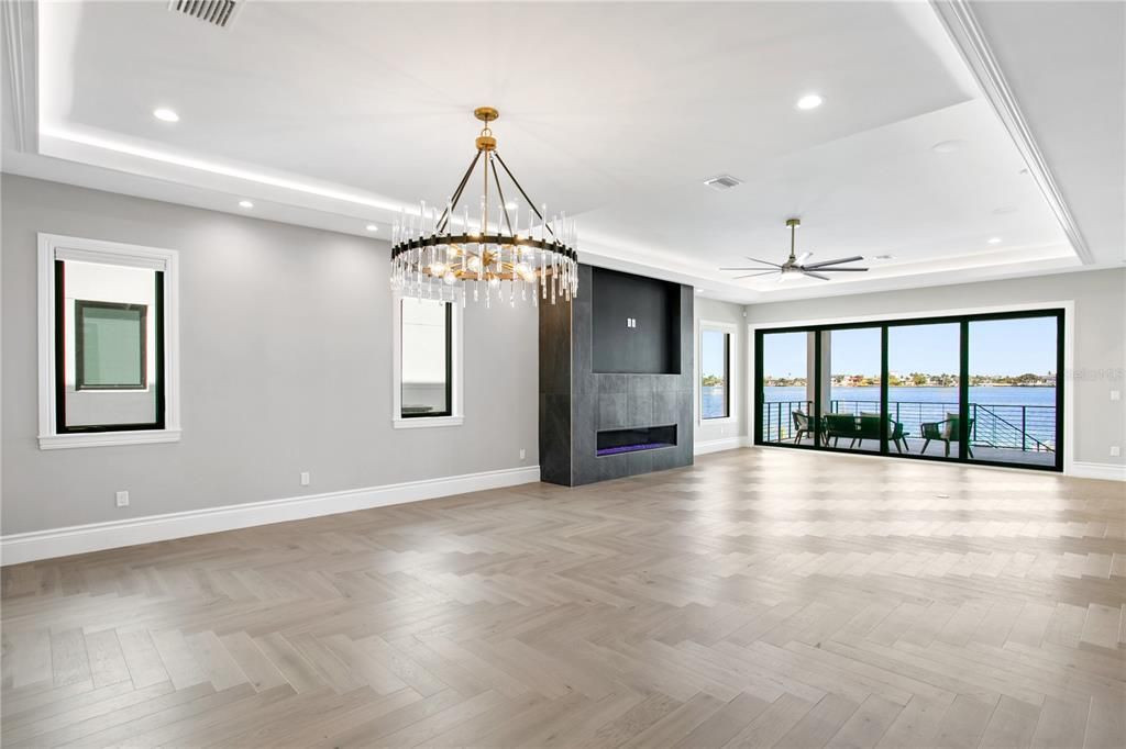 view from wet bar area to open concept living room to water views